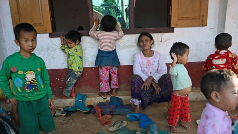 A woman and children affected by clashes between the Myanmar military and ethnic rebel groups seek temporary shelter at Kho Lone Buddhist monastery in Kutkai, Myanmar's northern Shan State, Aug. 25, 2019.