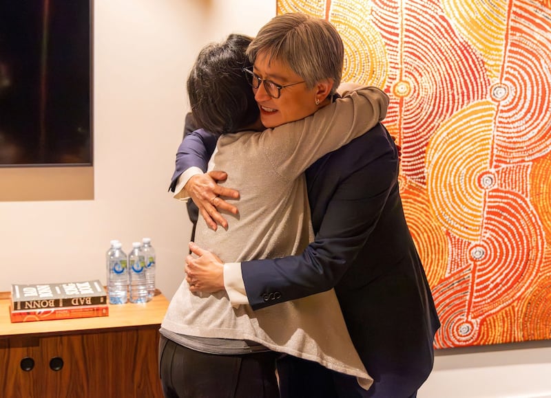 Australian Foreign Minister Penny Wong hugs Australian journalist Cheng Lei on arrival at Melbourne Airport in Melbourne, Wednesday, Oct. 11, 2023. Credit: AAP Image/Supplied by the Department of Foreign Affairs and Trade via Reuters