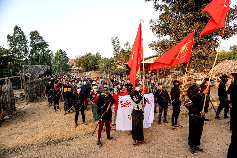 People's Defense Force militia members escort protesters during a demonstration in Monywa, capital of Myanmar's Sagaing region, on the anniversary of the military junta's coup, Feb. 1, 2022. Credit: Myanmar Pressphoto Agency.