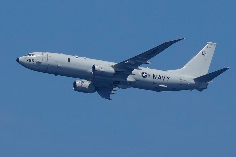 A U.S. Navy plane flies over the Ayungin Shoal during a Philippine resupply mission to the BRP Sierra Madre, Aug. 22, 2023. Credit: Aaron Favila/AP