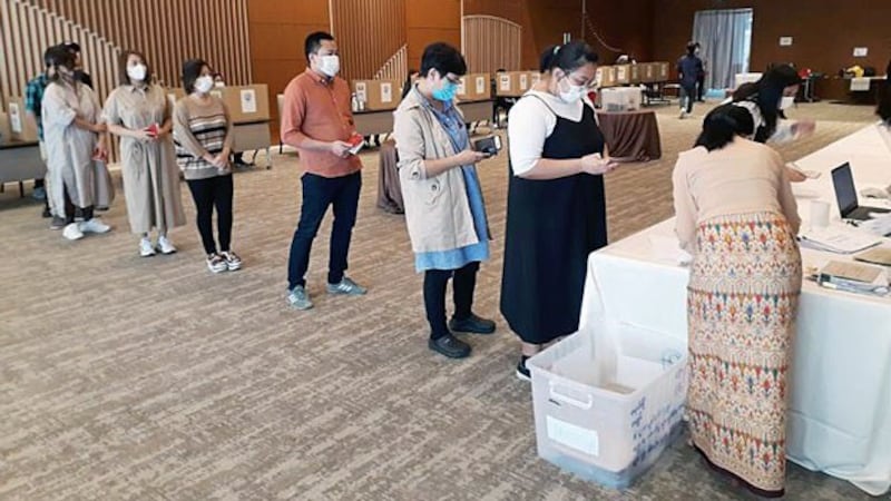 Myanmar nationals line up inside the Myanmar Embassy in Tokyo, Japan, on Oct. 6, 2020, to cast absentee ballots for the upcoming elections in their home country.