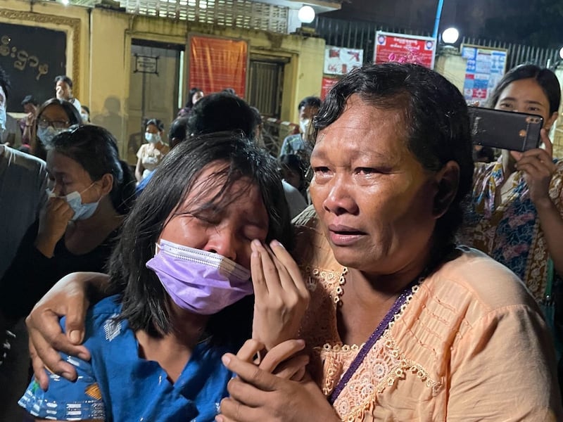 Ngu Wah Khine (L) is embraced by her mother following her release from Insein Prison in Yangon, Oct. 18, 2021. RFA