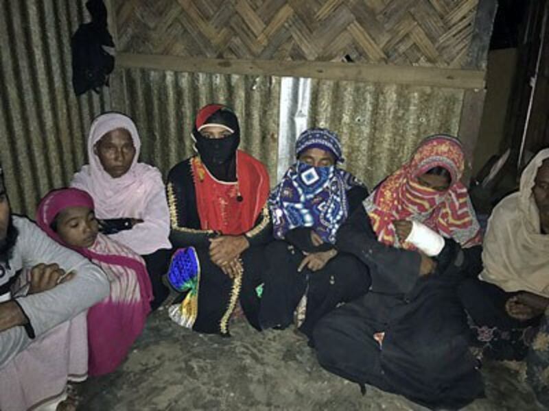 Rohingya Muslim women, sheltered in a house at Kutupalang Rohingya camp in Bangladesh, talk about the abuse they endured during security operations in western Myanmar's Rakhine state, Jan. 27, 2017. 