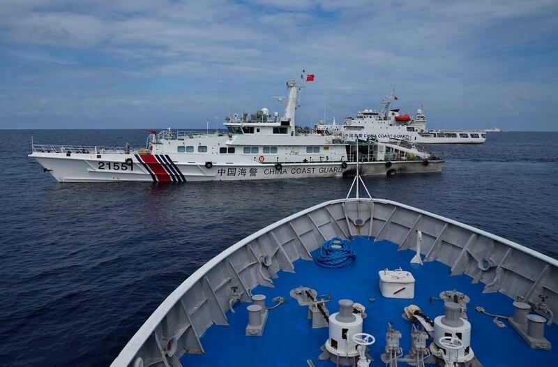 Chinese coast guard ships block Philippine coast guard BRP Cabra as it tried to head towards Second Thomas Shoal at the disputed South China Sea during a rotation and resupply mission on Aug. 22, 2023. (Aaron Favila/AP)