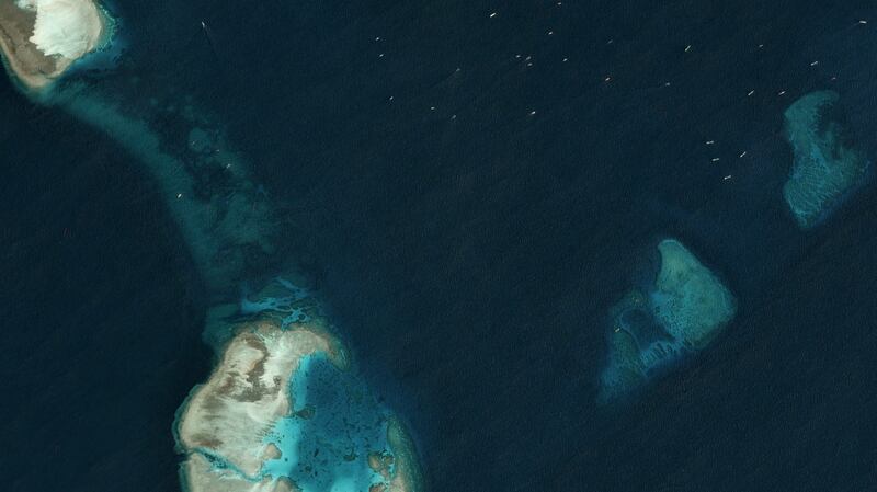 Satellite image taken just north of the Chinese-occupied base at South Johnson Reef, in which multiple, unidentified vessels can be seen in the top right hand corner, March 22, 2020. 