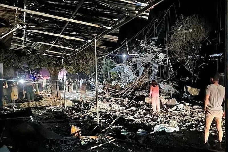 People gather around a destroyed building following an airstrike in Namhkham township in Myanmar's northern Shan state, Sept. 6, 2024.