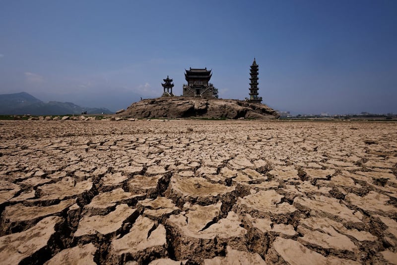 Pagodas on Louxingdun Island that are usually partially submerged in Poyang Lake are exposed by low water levels in Lushan, Jiangxi province, China, August 24, 2022. Credit: Reuters