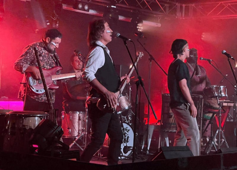 Uyghur musician Shohret Tursun (C) performs onstage with a band in an undated photo. Photo courtesy of Shohret Tursun