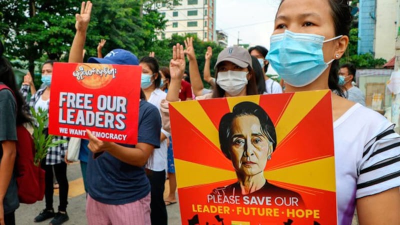 Myanmar anti-junta protesters disply signs calling for the release of deposed State Counselor Aung San Suu Kyi and other leaders as they march along a street in Yangon, April 24, 2021. AP