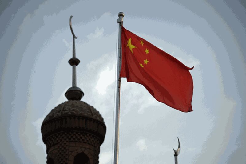 The Chinese flag flies over the a mosque in the restored old city area of Kashgar in northwestern China's Xinjiang region, June 4, 2019. Credit: AFP