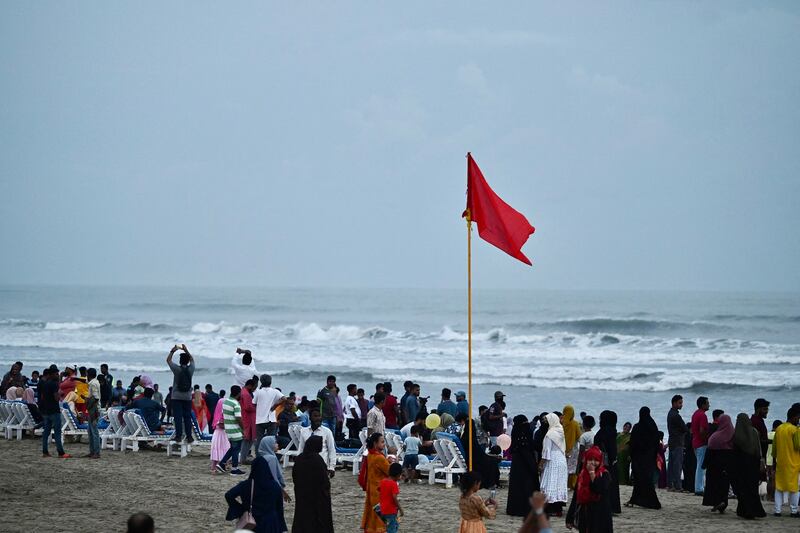 People gather at the beach in Cox's Bazar, Bangladesh, on Friday, May 12, 2023, ahead of the landfall of cyclone Mocha. Credit: AFP