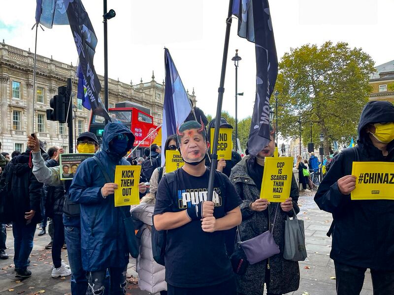 A protester in London wears a devil mask of Chinese leader Xi Jinping's face in this Oct. 23, 2022, photo. (Credit: RFA London Correspondent Amelia Loi)