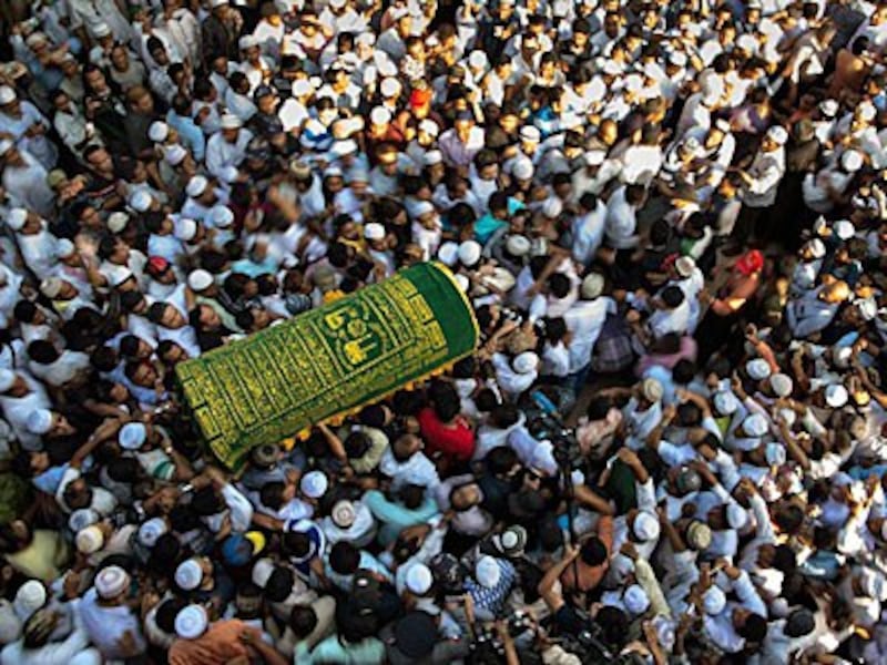 Mourners carry the coffin of prominent Muslim lawyer Ko Ni at a Muslim cemetery in Yangon, Jan. 30, 2017.