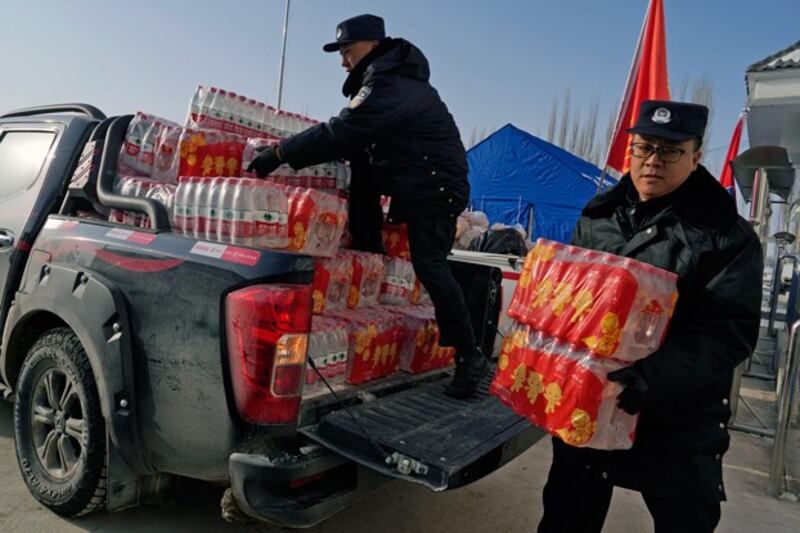 Chinese officials deliver supplies to a shelter in Yamansu township, Aksu prefecture, in northwestern China's Xinjiang region, Jan. 24, 2024. (Ng Han Guan/AP)