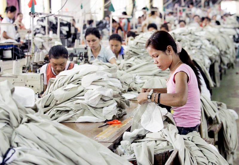 Factory workers assemble garments to be exported abroad on the outskirts of the Laotian capital Vientiane May 2, 2006. (Sukree Sukplang/Reuters)