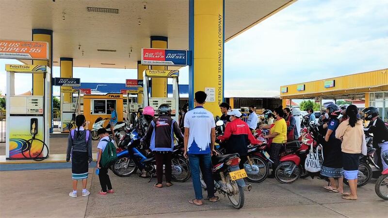 In this May 10, 2022 photo, motorcyclists line up for gas in Laos amid shortages. Credit: RFA