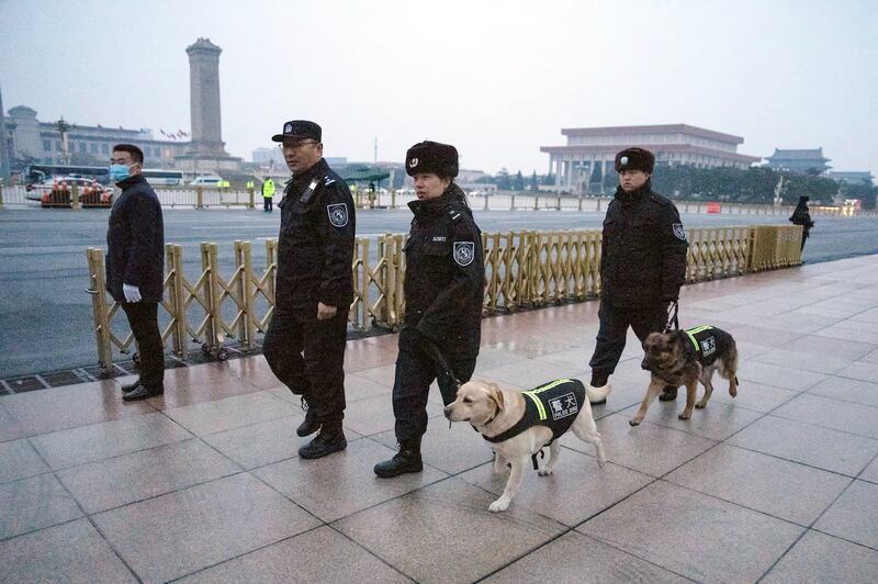 Police patrol Tiananmen Square with dogs on the first day of the National People's Congress, March 5, 2024