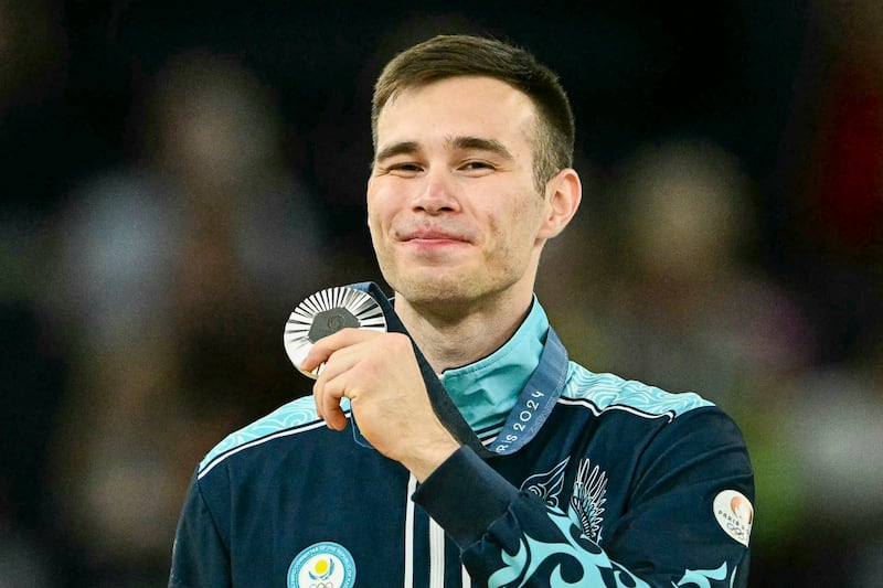 Kazakhstan's Nariman Kurbanov poses with his silver medal during the podium ceremony for the artistic gymnastics men's pommel horse during the Paris 2024 Olympic Games at the Bercy Arena in Paris, Aug. 3, 2024. (Lionel Bonaventure/AFP)