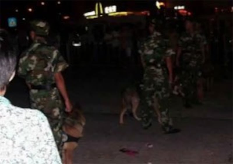 Police patrol the streets of Shenzhen with dogs on the night of September 4 in this citizen reporter's cell phone photo posted online and sent to our reporter.