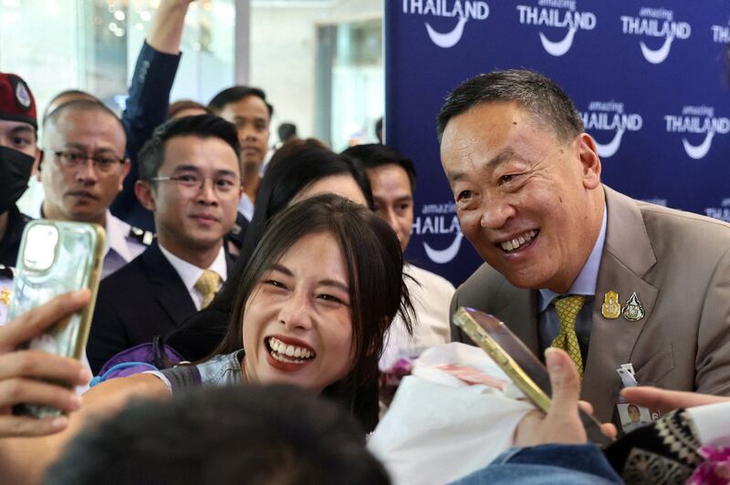 A Chinese tourist takes a selfie with Thailand’s Prime Minister Srettha Thavisin, during a welcome ceremony for the first batch of Chinese tourists under a five-month visa-free entry scheme at Bangkok’s International Airport, Sept. 25, 2023. (Athit Perawongmetha/Reuters)