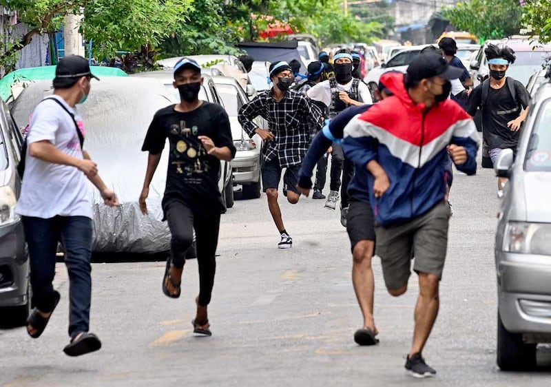 Their mission accomplished, protesters flee as security forces descend on the scene. (AFP)