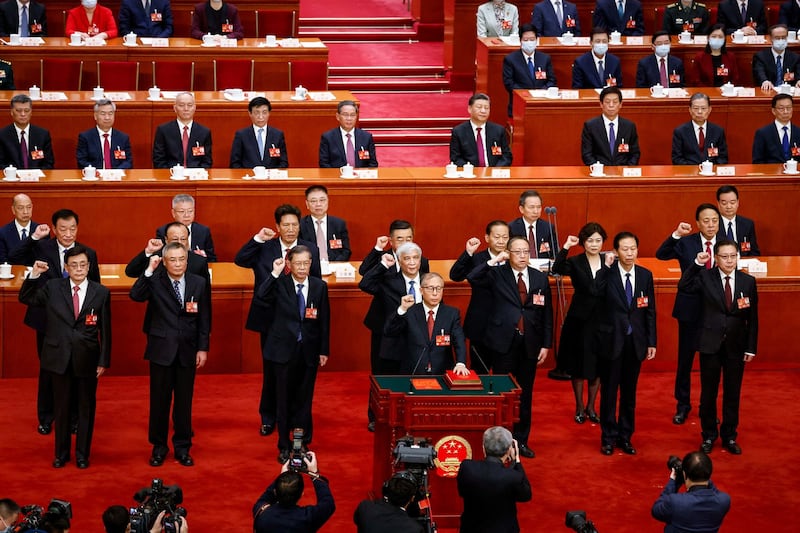 Newly elected delegates take their oaths during the Third Plenary Session of the National People's Congress at the Great Hall of the People, in Beijing, Friday, March 10, 2023. Credit: Pool via Reuters