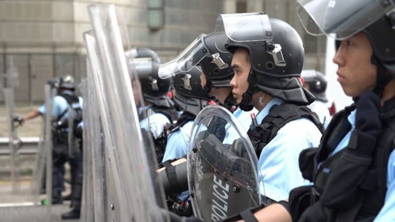 A line of riot police brace for protesters in Hong Kong, June 12, 2019.