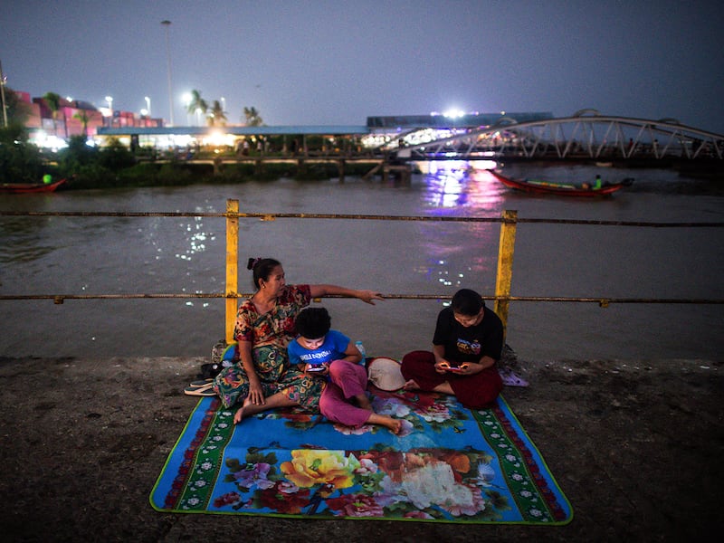 People gather at a jetty during an electricity blackout in Yangon, Myanmar, on April 26, 2024.