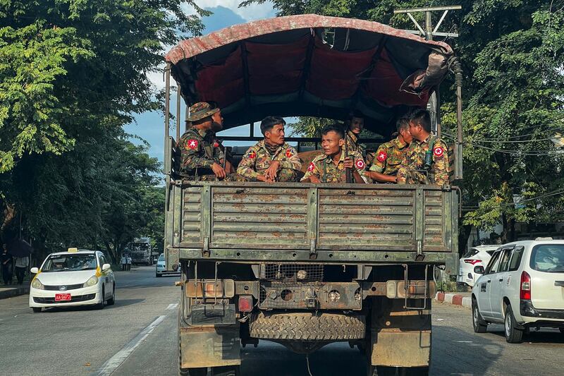 Myanmar's military junta soldiers on a truck patrol in Yangon, Dec. 4, 2023. Reports from the ground suggest that the military is building up its defenses in Naypyidaw, Yangon, and Mandalay, with increasing shows of force and patrols of armed vehicles. (AFP photo)