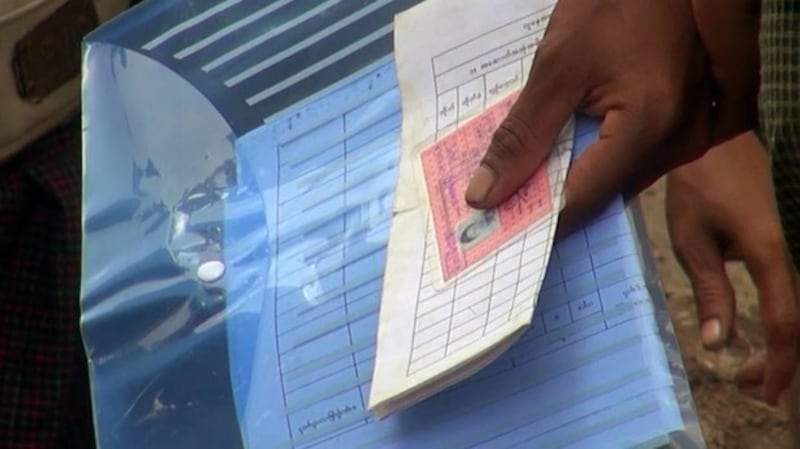 File photo of a man who brought the original copies of the national ID and Family Table List to the passport office in Yangon. Credit- RFA.jpeg