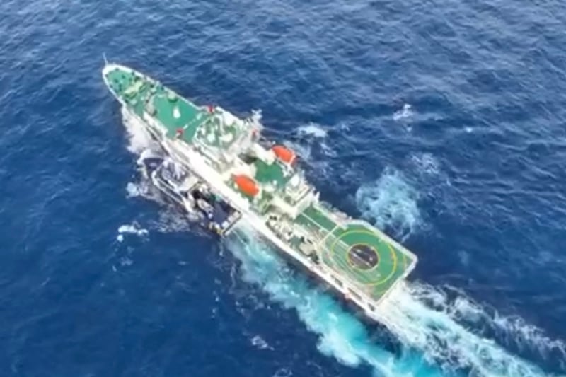 A China Coast Guard ship (R) and the Philippine Bureau of Fisheries and Aquatic Resources vessel BRP Datu Pagbuaya (L) near Scarborough Shoal in disputed waters of the South China Sea.