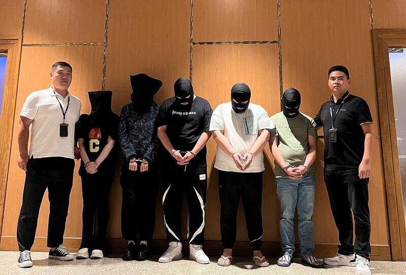 Myanmar police hand over five telecom and internet fraud suspects to Chinese police at Yangon International Airport, Aug. 26, 2023. (Chinese embassy in Myanmar/Xinhua via AP)