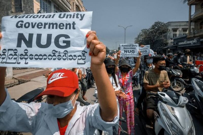 Protesters holding signs supporting the newly formed opposition National Unity Government as they take part in a demonstration against the military coup in Shwebo in Myanmar's Sagaing region, April 18, 2021. Credit: AFP/anonymous source via Facebook