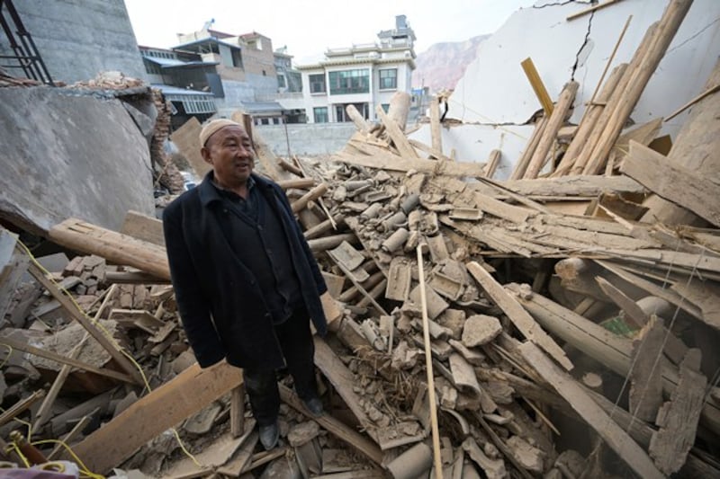 A man inspects a damaged building after the earthquake in Dahejia in northwestern China's Gansu province, Dec. 20, 2023. (Pedro Pardo/AFP)