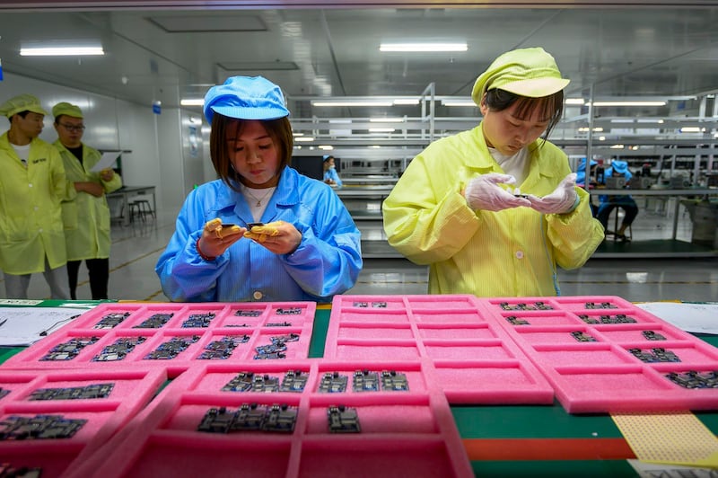 Employees check electronic components at the workshop of Jiangxi Yingteli Electronic Technology Co., Ltd., June 8, 2023 in Jincheng, Shanxi, China. (Wei Liang/China News Service/VCG via Getty Images)