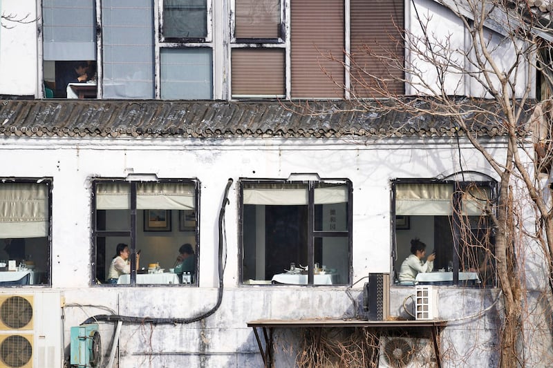 People eat at a restaurant near the Forbidden City in Beijing, China, March 16, 2024. (Tatan Syuflana/AP)