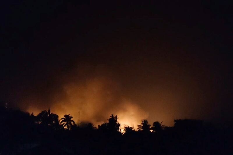 Flames from burning homes in Buthidaung in Rakhine state, are seen above the treetops in this image provided by a Rohingya refugee, May 17, 2024. (Image from video via AP)