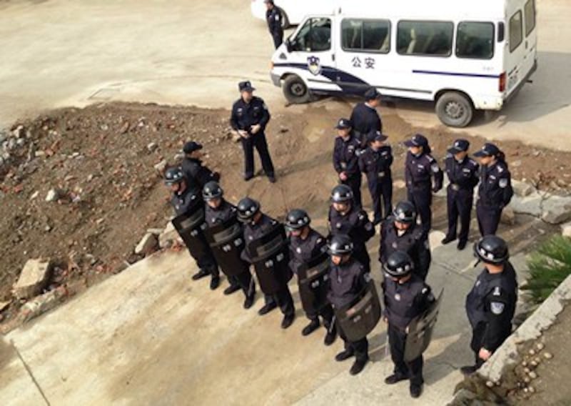 Police surround the building where the activists are staying in Suzhou, April 29, 2015.