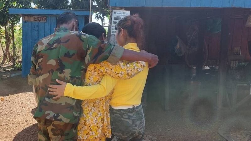 A Cambodian victim of trafficking (c) hugs her parents after she returns home from being rescued in China, in an undated photo.