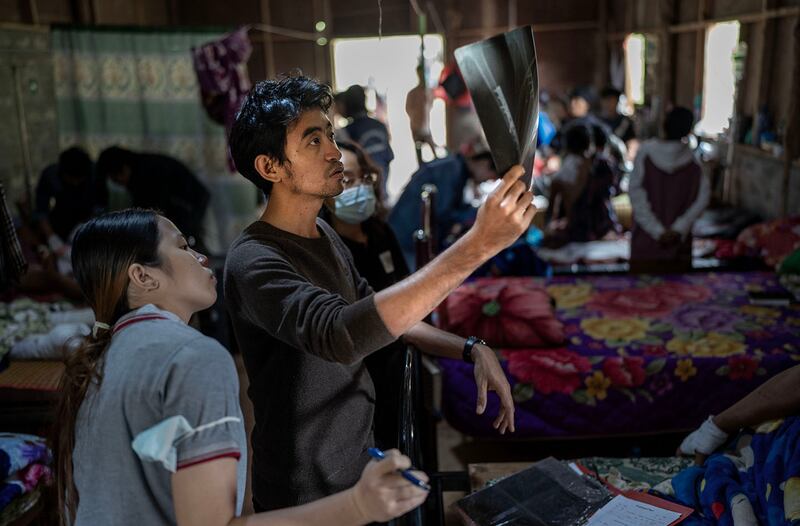 Drs. Aung Ko Myint, right, and Tracy look at an X-ray at O-1 hospital in Demoso, Kayah state, Myanmar, Nov. 10, 2024.