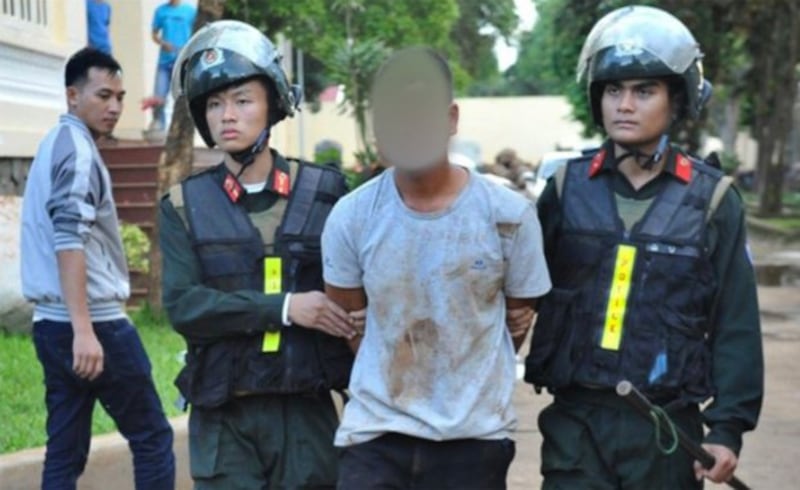 Vietnamese police officers escort a suspect arrested in Dak Lak province. Credit: Vietnamese State media