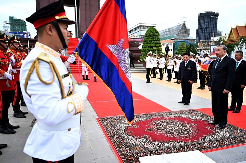 Vietnam's President To Lam, front right, and Cambodia's Defense Minister Tea Seiha, back right, pay their respects in front of honor guards at the Independence Monument in Phnom Penh on July 13, 2024. (Tang Chhin Sothy/AFP)