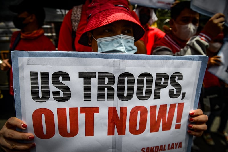 Protesters denounce an Enhanced Defense Cooperation Agreement that allows U.S. forces to use Philippine military sites, during a May Day demonstration outside the American embassy in Manila, May 1, 2023. Credit: Jojo Riñoza/BenarNews