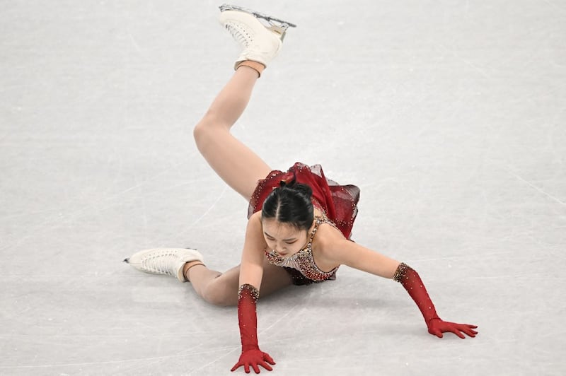 China's Zhu Yi falls as she competes in the women's single skating free skating of the figure skating team event during the Beijing 2022 Winter Olympic Games at the Capital Indoor Stadium in Beijing, Feb. 7, 2022. Credit: AFP