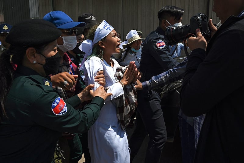 Cambodian environmental activist Phuon Keoraksmey is arrested outside the Phnom Penh municipal court after a verdict on July 2, 2024. (Tang Chhin Sothy/AFP)