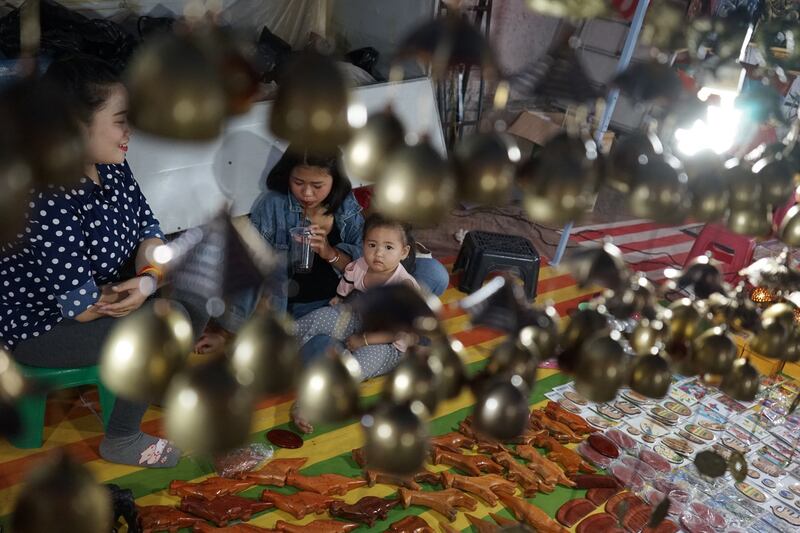 Vendors wait for customers at the main tourist market in Luang Prabang, Laos, Feb. 2020. Several women who spoke with RFA said the country's gender imbalance is gradually improving. Credit: AFP