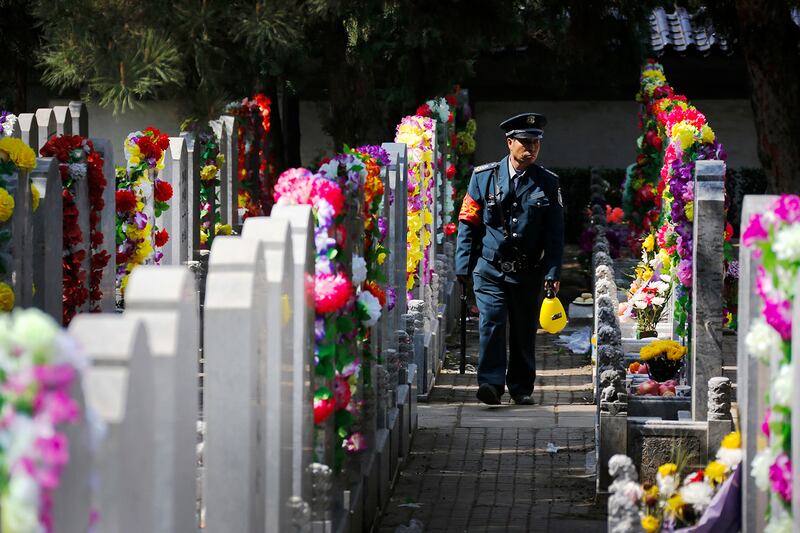 A security person patrols in the Babaoshan Cemetery in Beijing, April 2, 2017.