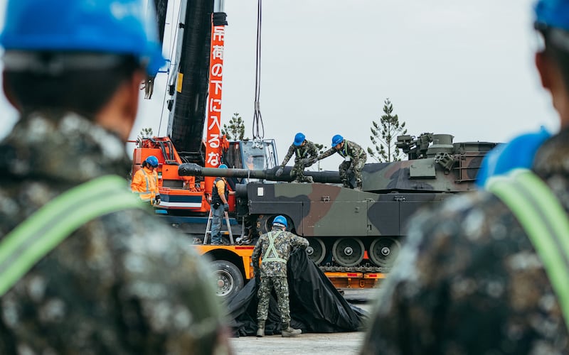 Soldiers securing a US-made M1A2 Abrams battle tank onto a trailer at an army armour training centre in Hsinchu County, Hsinchu on Dec. 16, 2024.