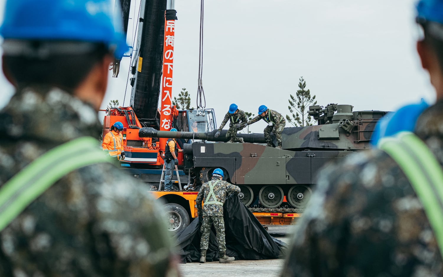 Soldiers securing a US-made M1A2 Abrams battle tank onto a trailer at an army armorr training center in Hsinchu County, Hsinchu on Dec. 16, 2024.