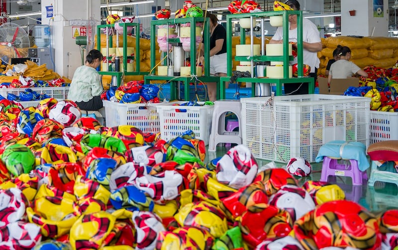 Employees stitch footballs at a sporting goods enterprise, July 22, 2024 in Wuchuan Gelao and Miao Autonomous County, Zunyi City, Guizhou, China. (Tang Zhe/China News Service/VCG via Getty Images)